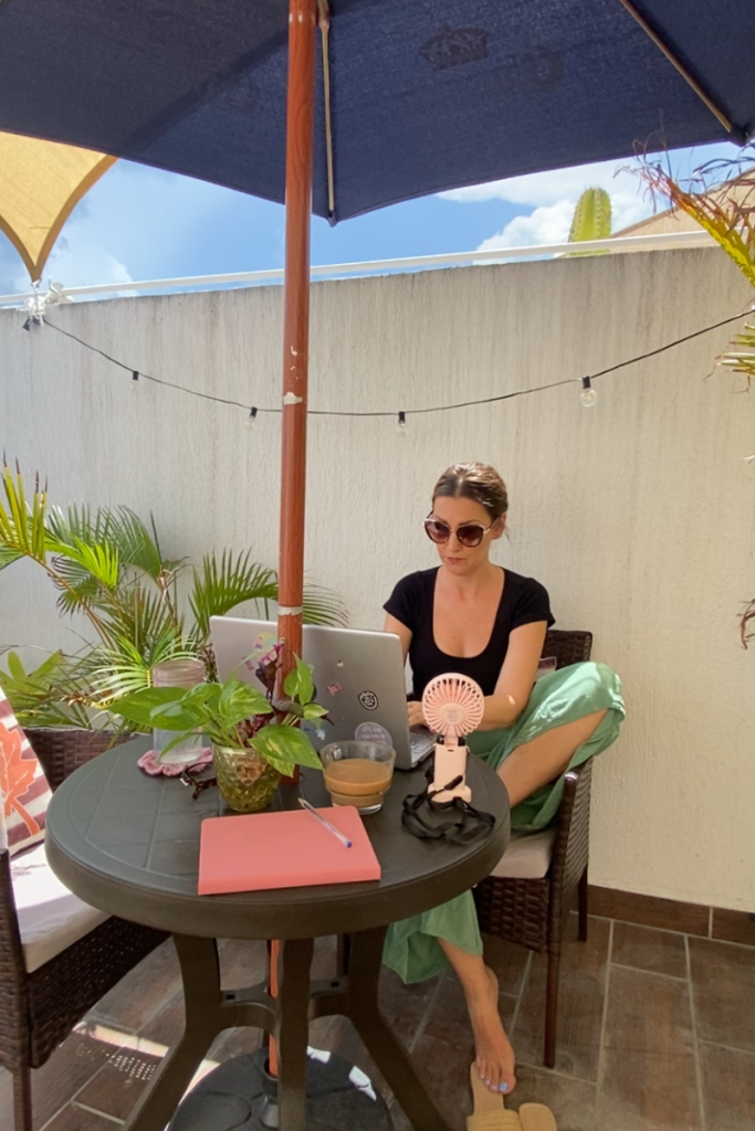 Example of a woman working from home, outside on a laptop