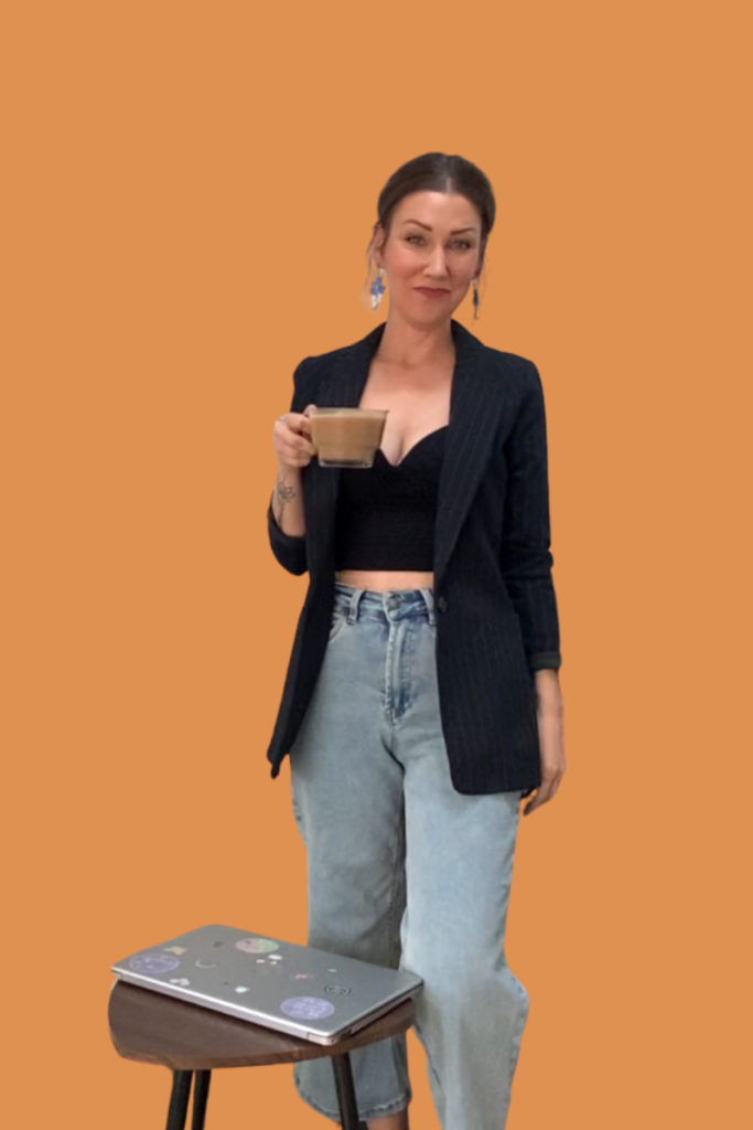 An entrepreneur, standing holding a coffee 